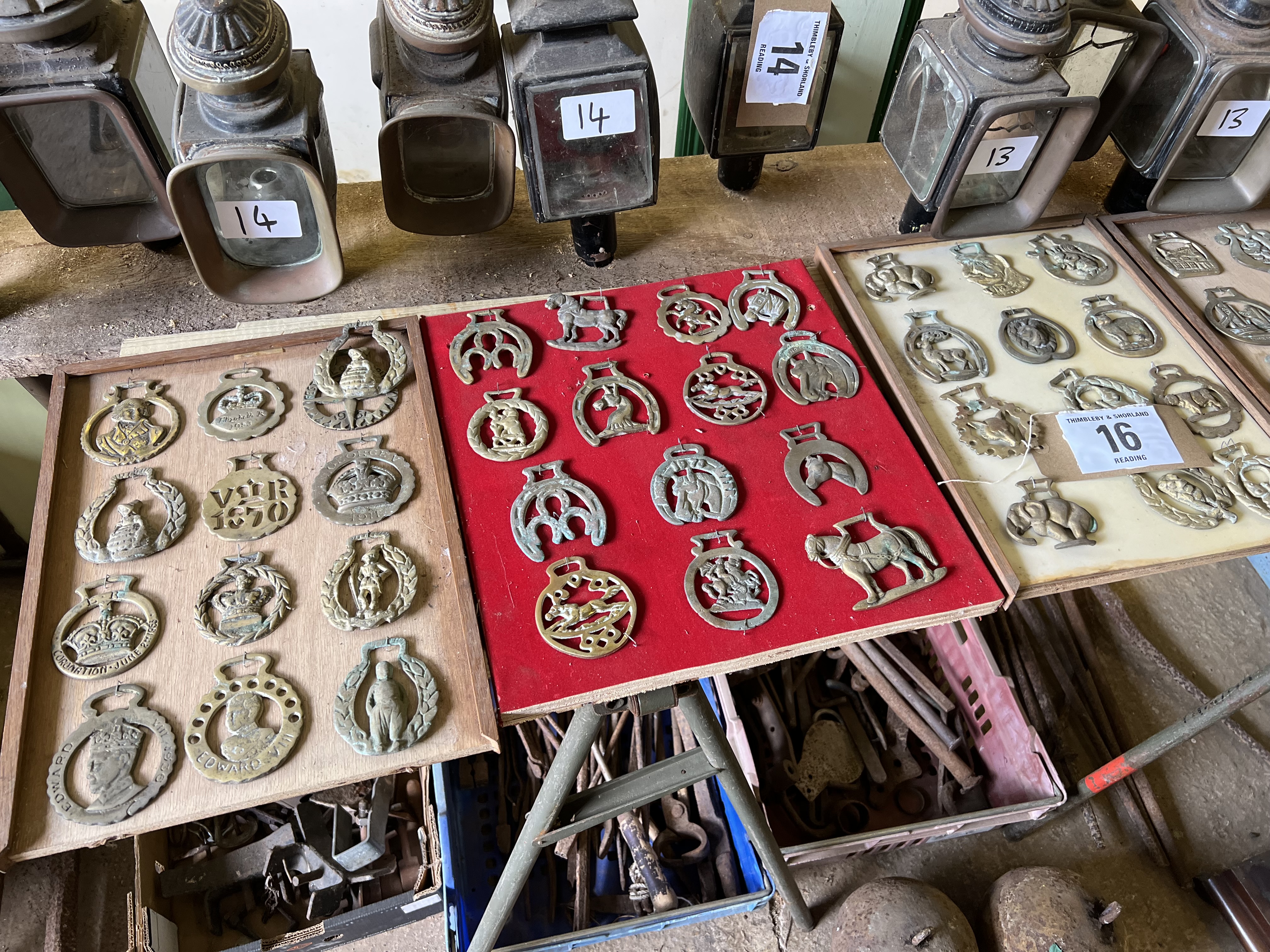 64 horse brasses mounted on wooden boards