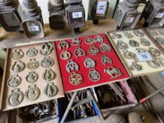 64 horse brasses mounted on wooden boards