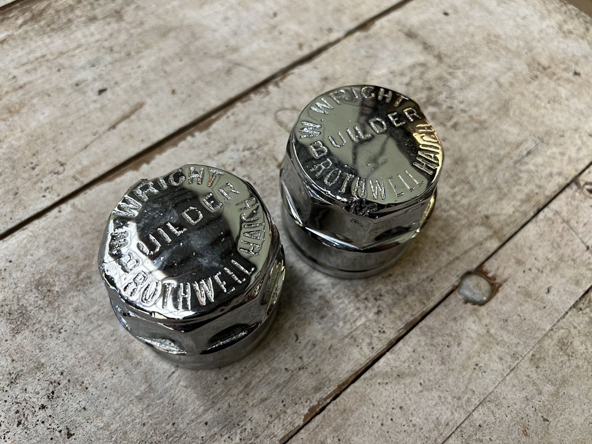 A pair of chromed hub caps engraved W Wright, Rothwell Haigh