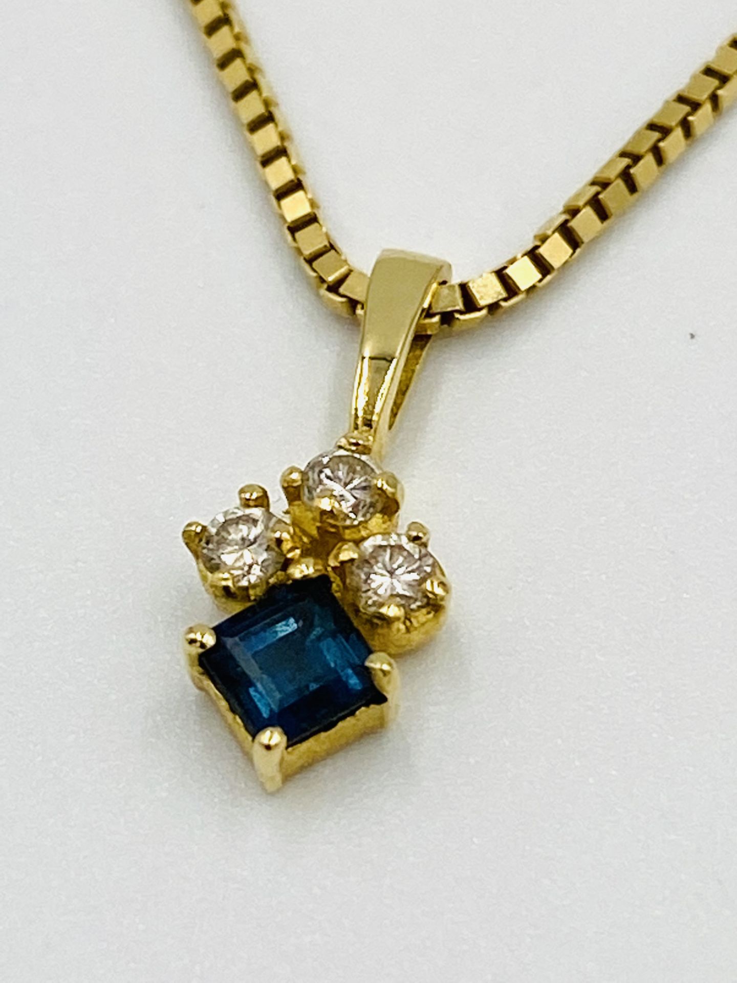 18ct gold pendant set with three diamonds on 14ct gold chain