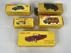 Five boxed Dinky toy vehicles including Volkswagen Beetle and Army covered wagon.