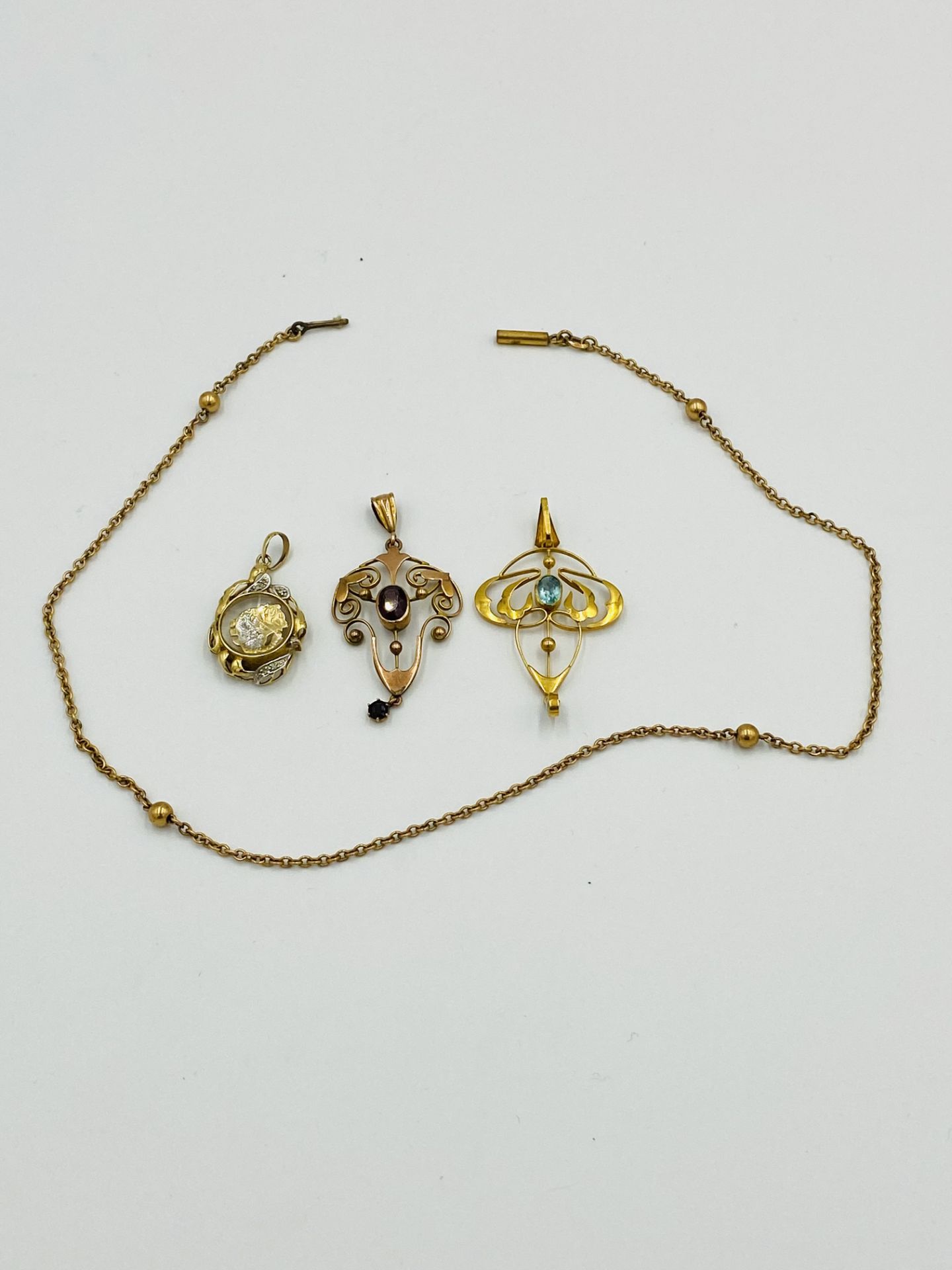18ct gold and diamond pendant together with two 9ct gold pendants