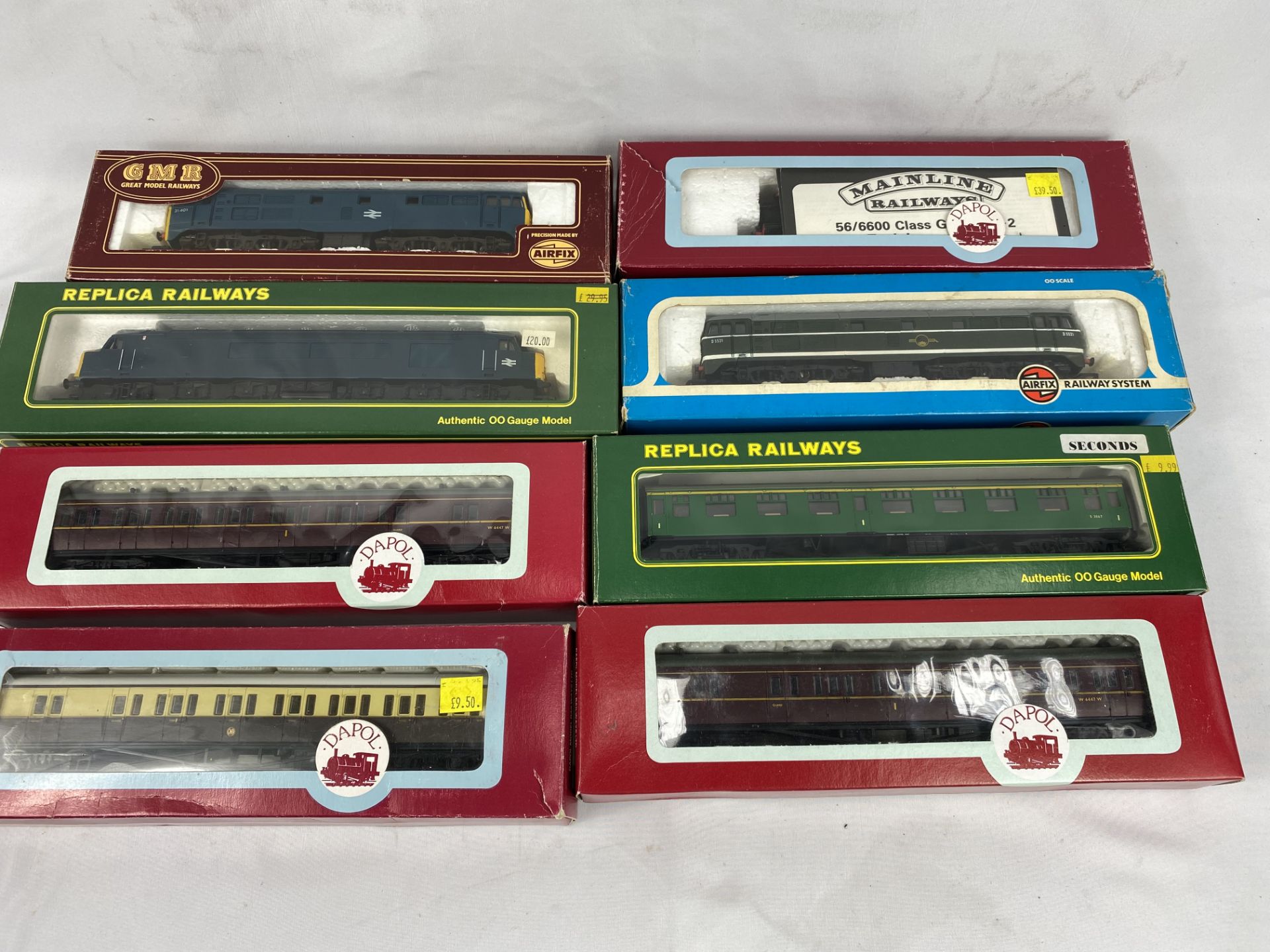 Four boxed 00 gauge locomotives together with four carriages