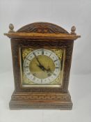 Oak cased mantel clock with brass face