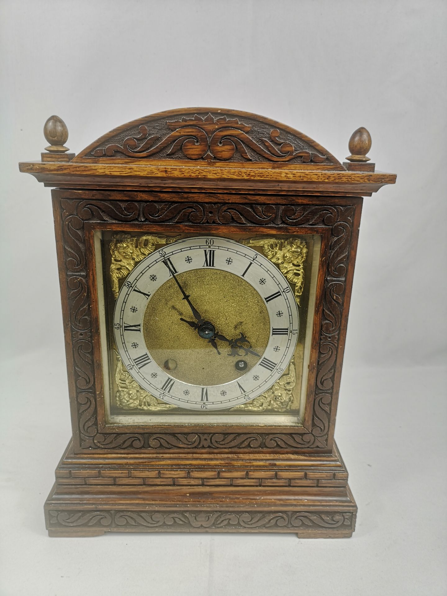 Oak cased mantel clock with brass face