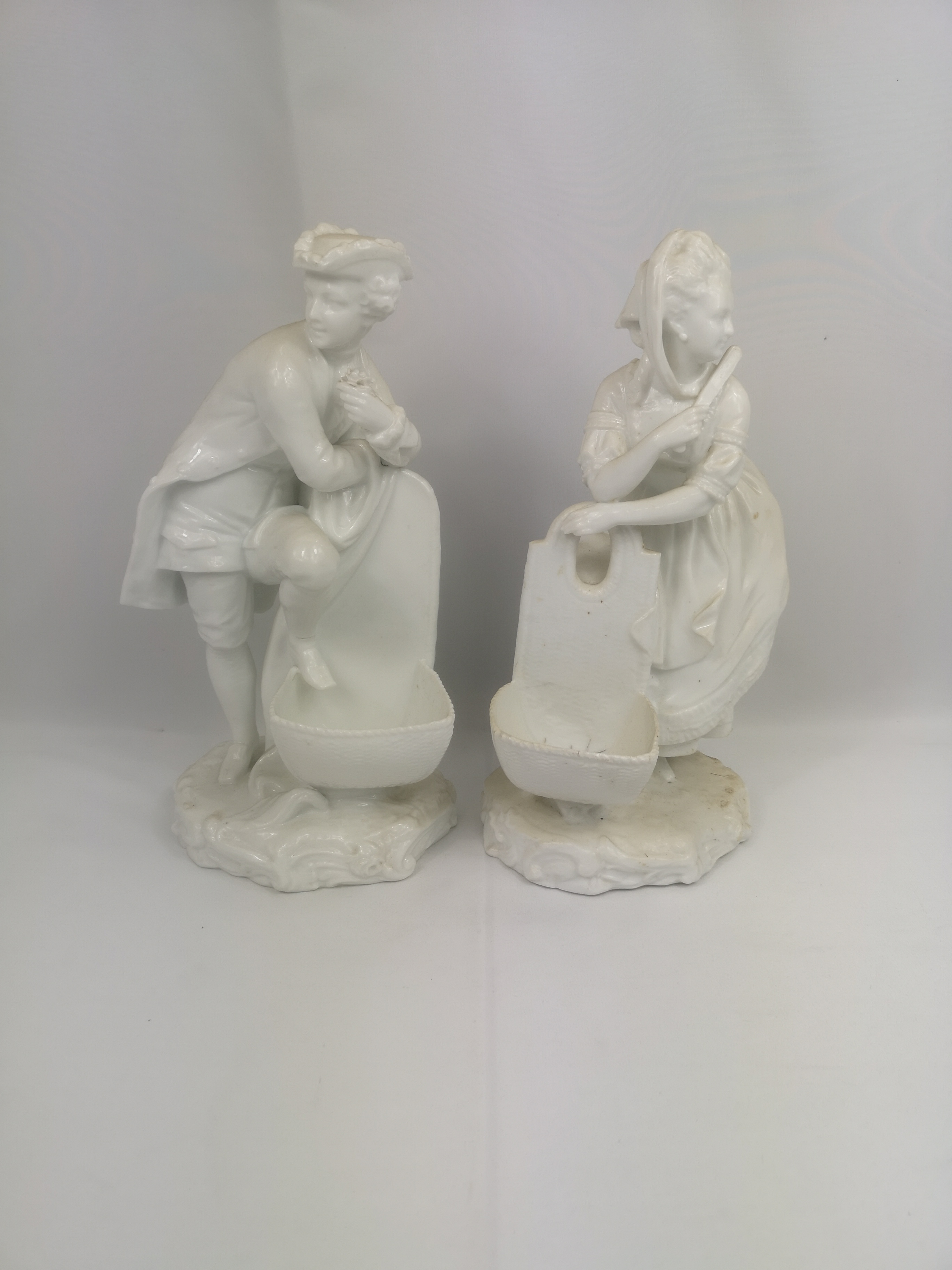 Two white Meissen style porcelain figures; and two Victorian Molineaux Webb glass biscuit barrels