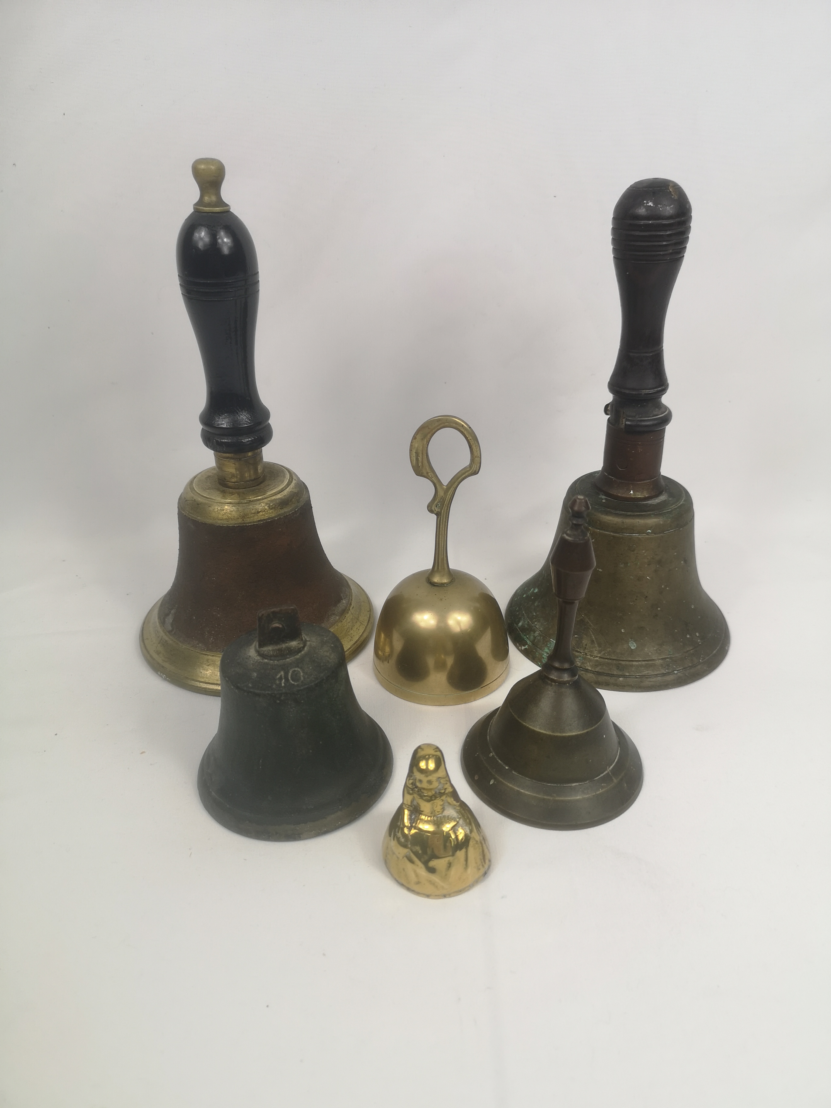 Four brass hand bells