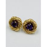 A pair of 9ct gold and amethyst circular 'whirl' earrings