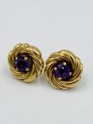 A pair of 9ct gold and amethyst circular 'whirl' earrings