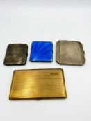 Three silver cigarette cases together with a brass cigarette case