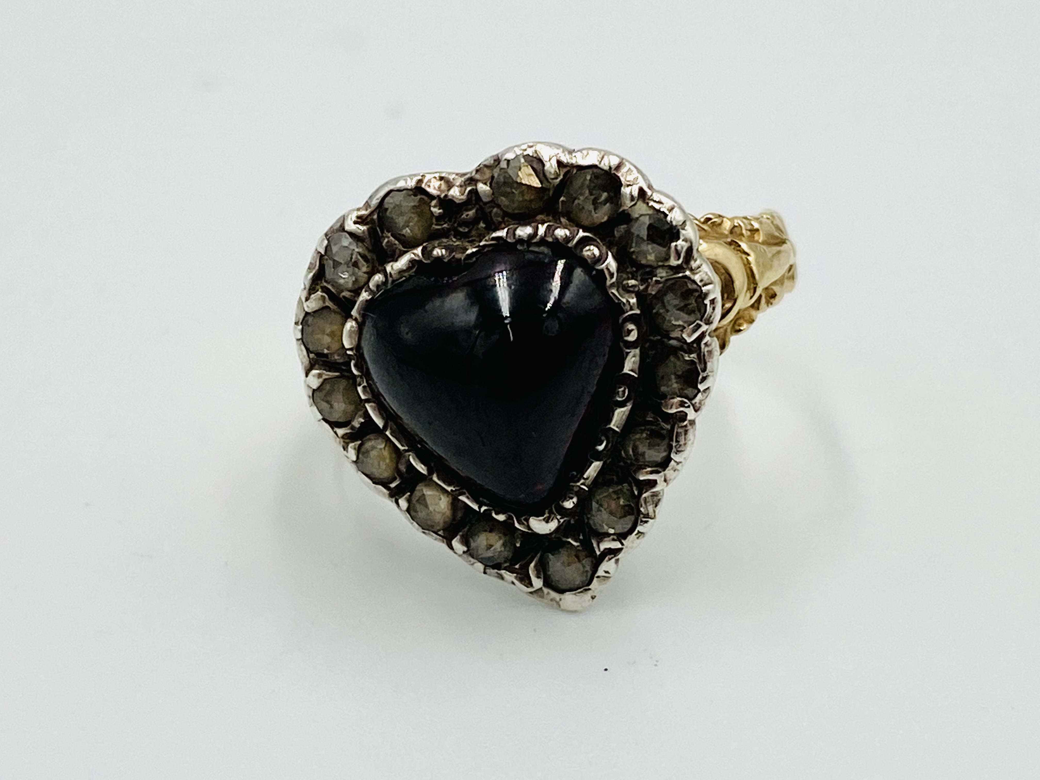 Gold and platinum set diamond and garnet heart shaped ring