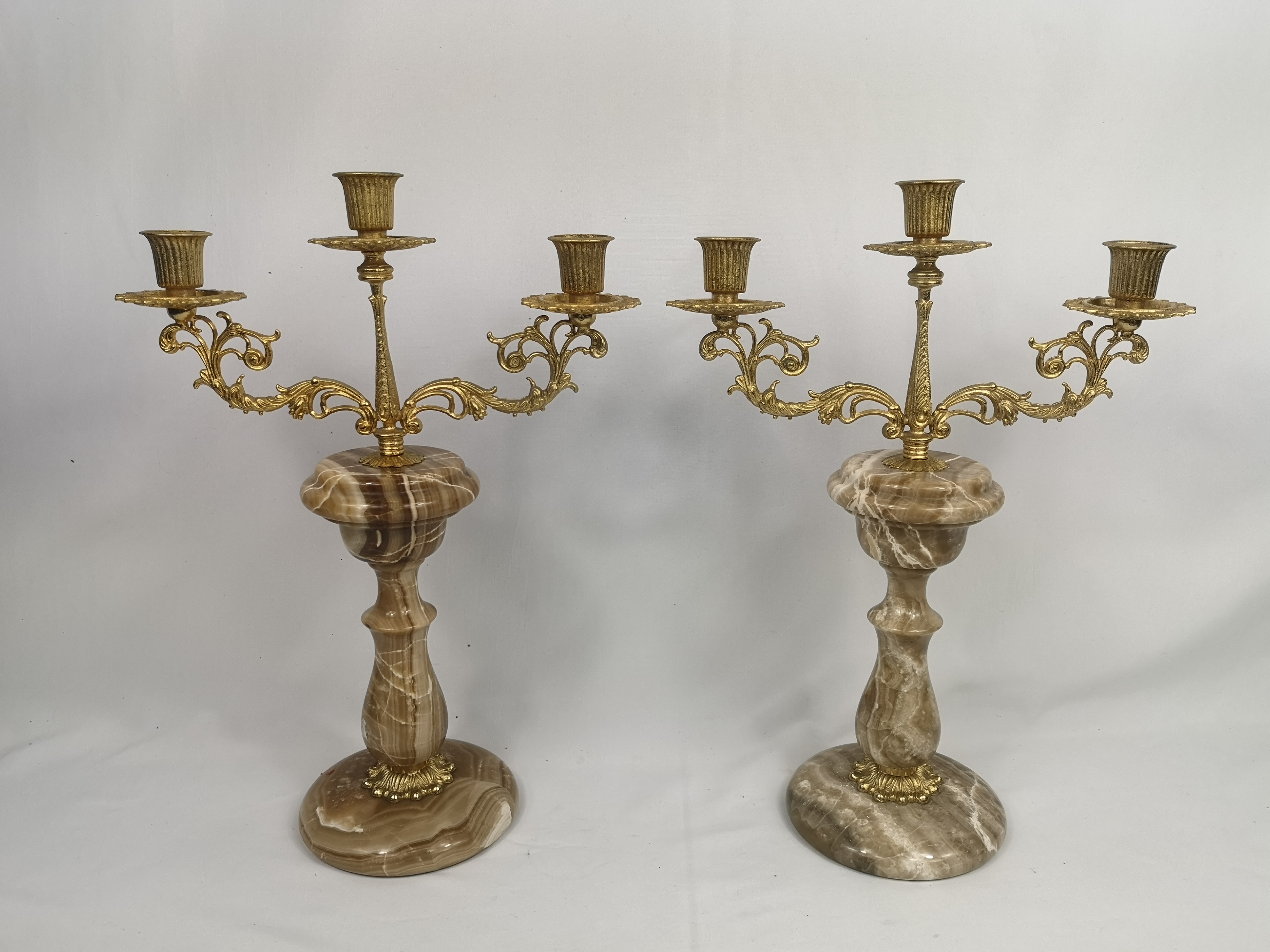 Pair of gilt metal candelabras on onyx bases