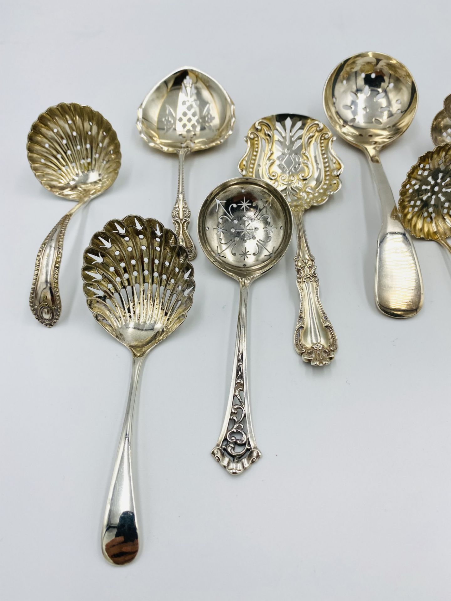 A collection of silver sugar sifters and a silver plated sugar sifter - Image 3 of 4