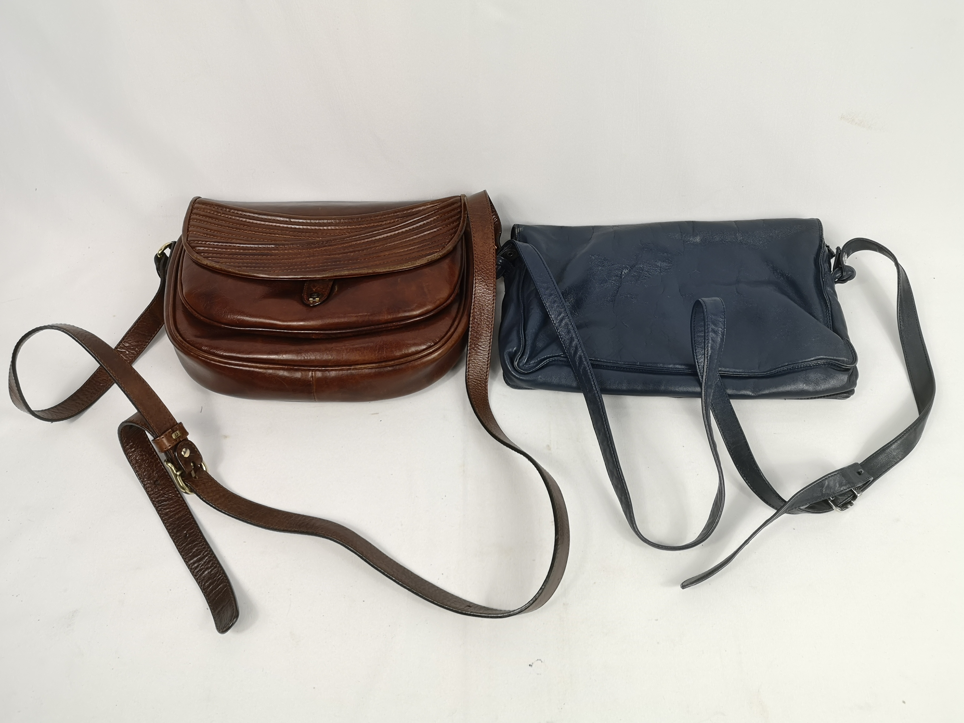 Brown leather cartridge style shoulder bag together with a blue Emy bag