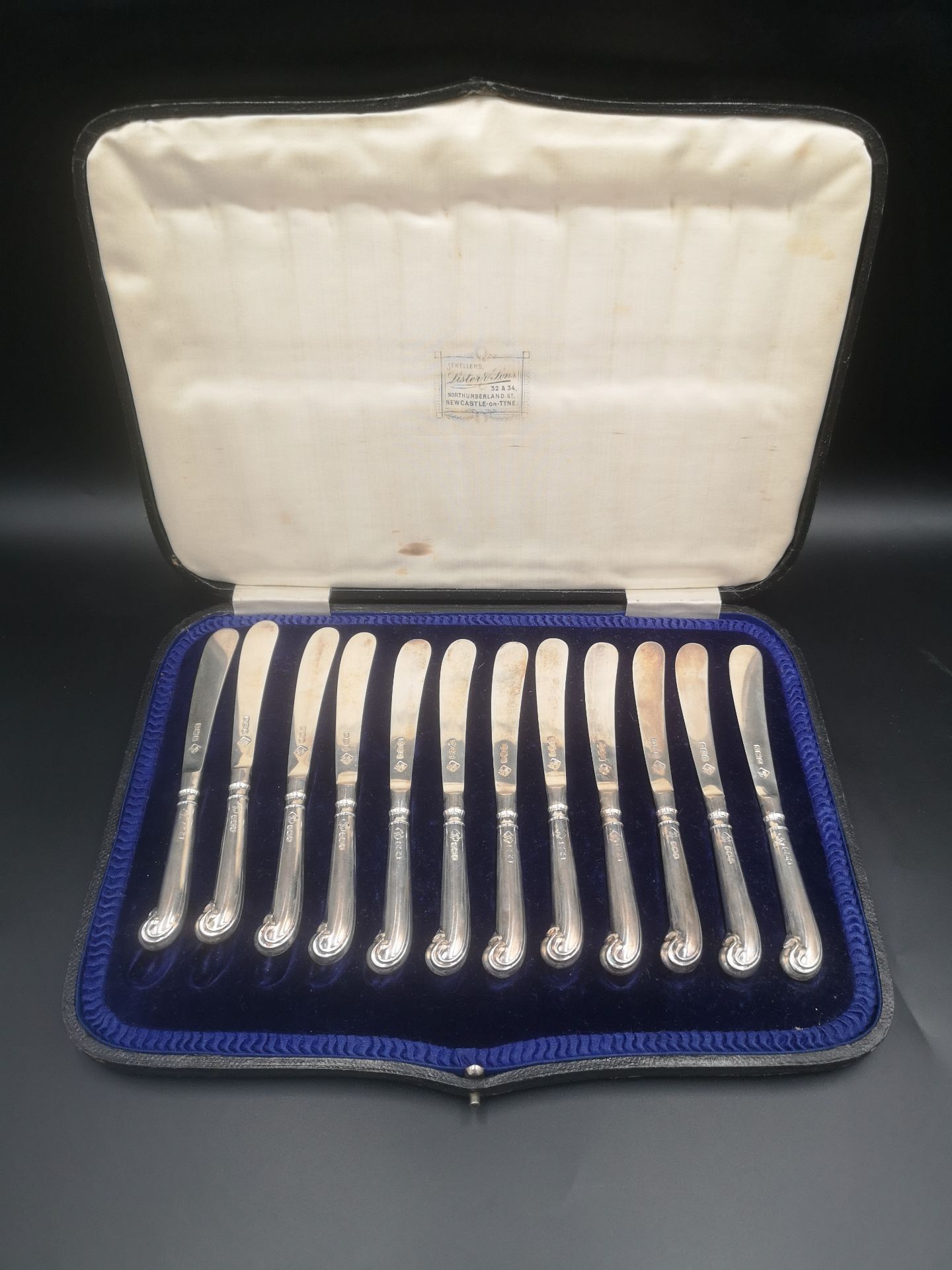Boxed set of twelve silver butter knives