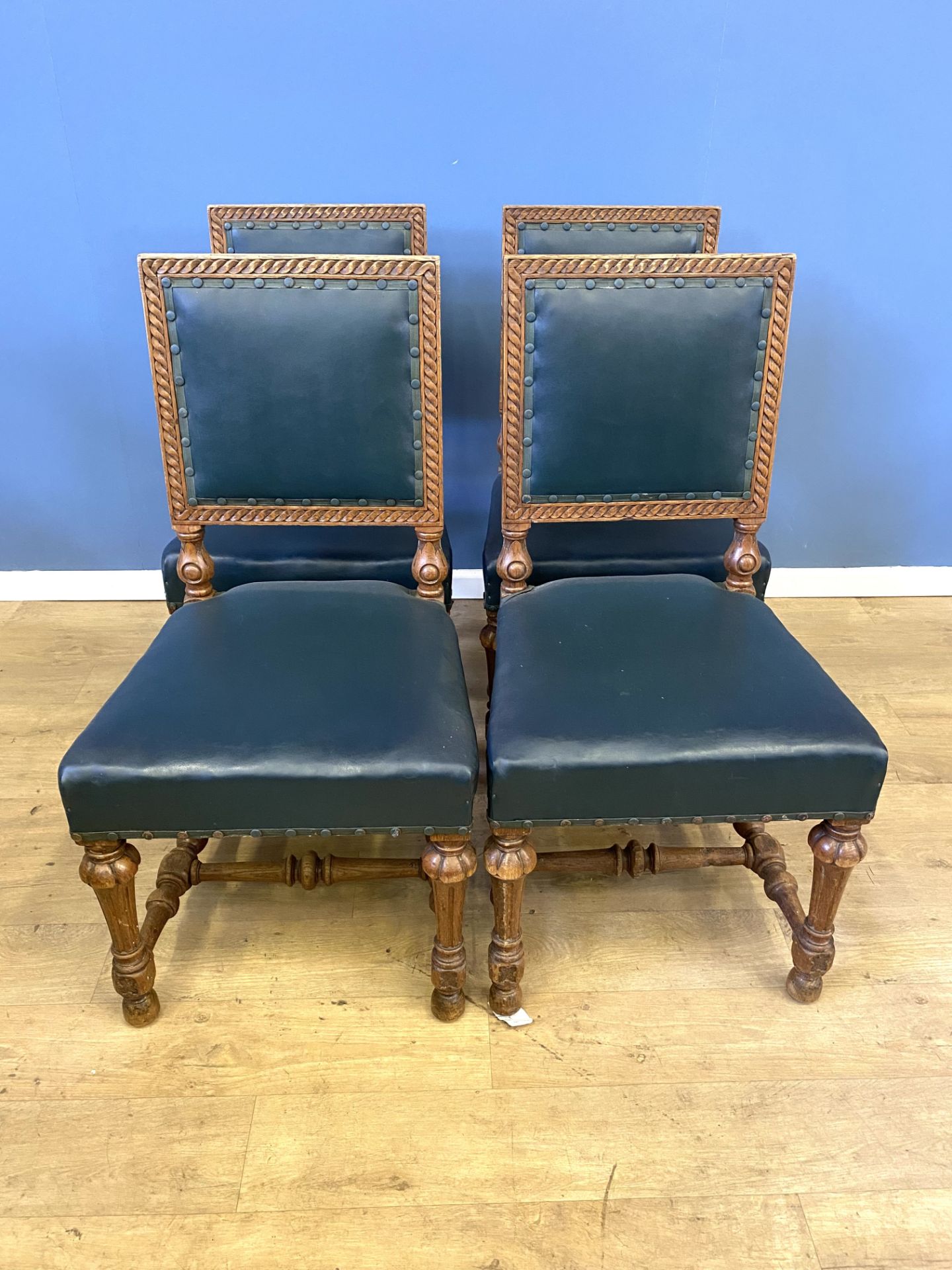Four carved oak dining chairs