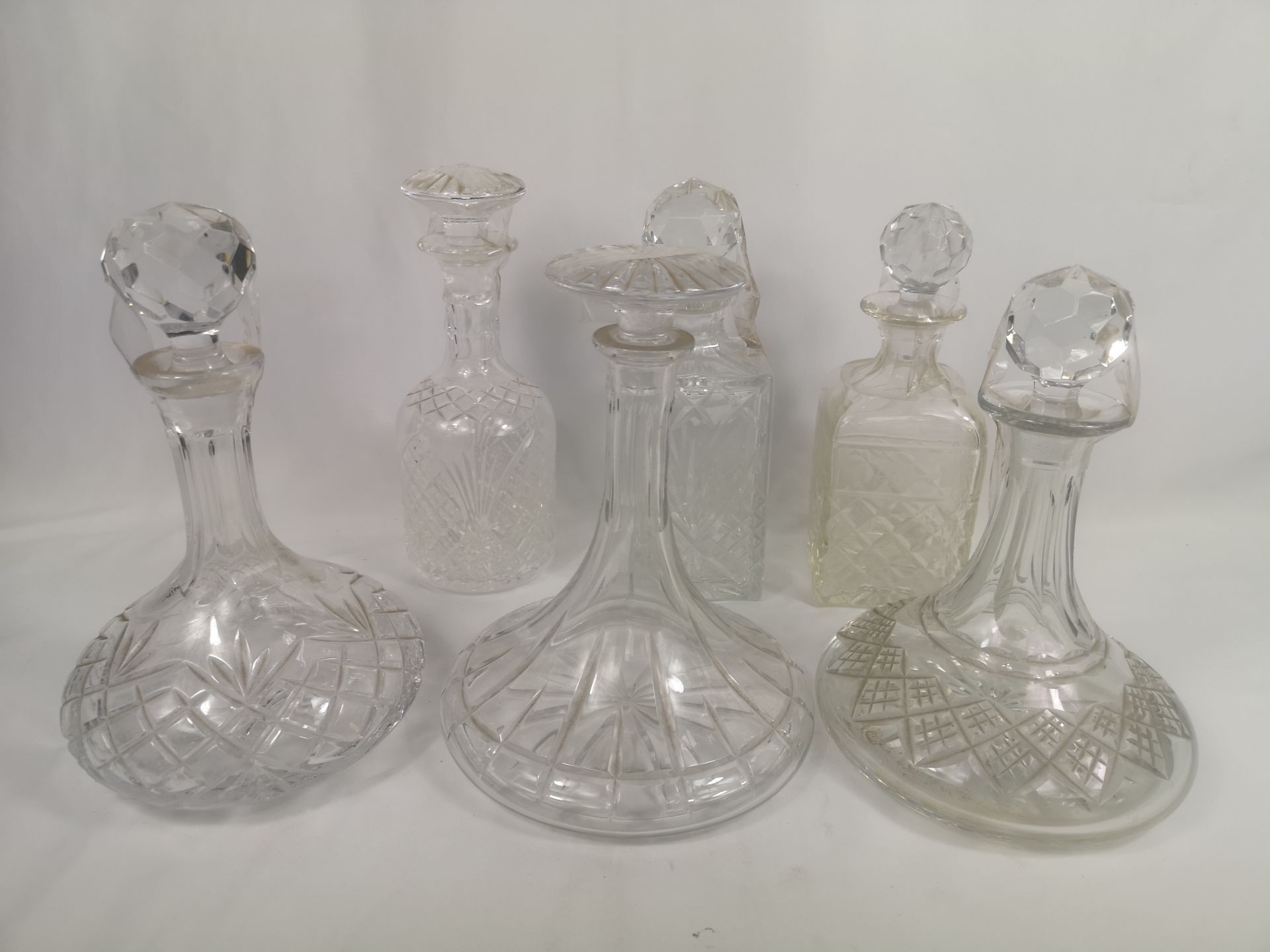 Six cut glass decanters