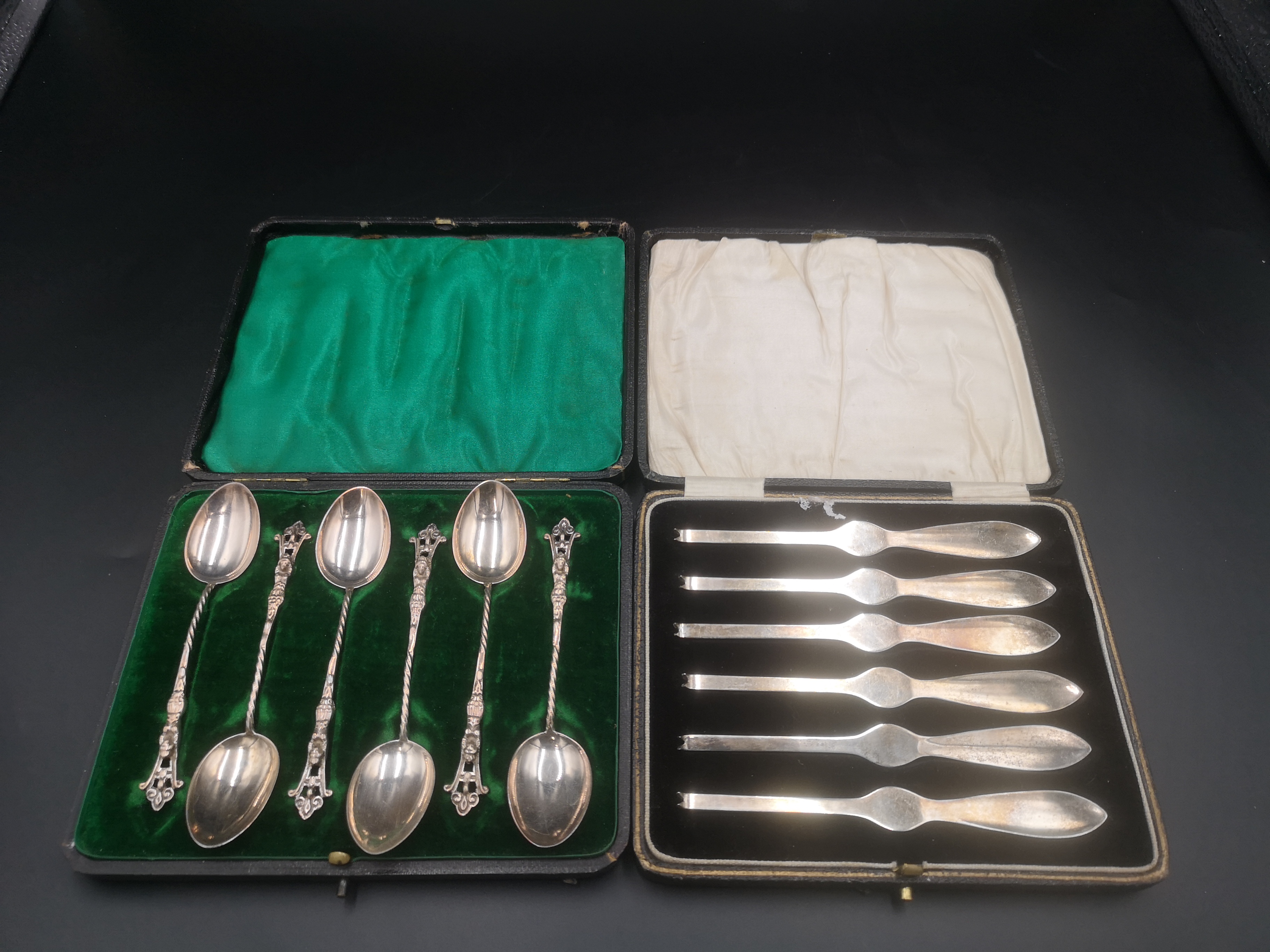 Boxed set of six silver apostle spoons together with a boxed set of six silver crab picks