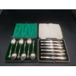 Boxed set of six silver apostle spoons together with a boxed set of six silver crab picks