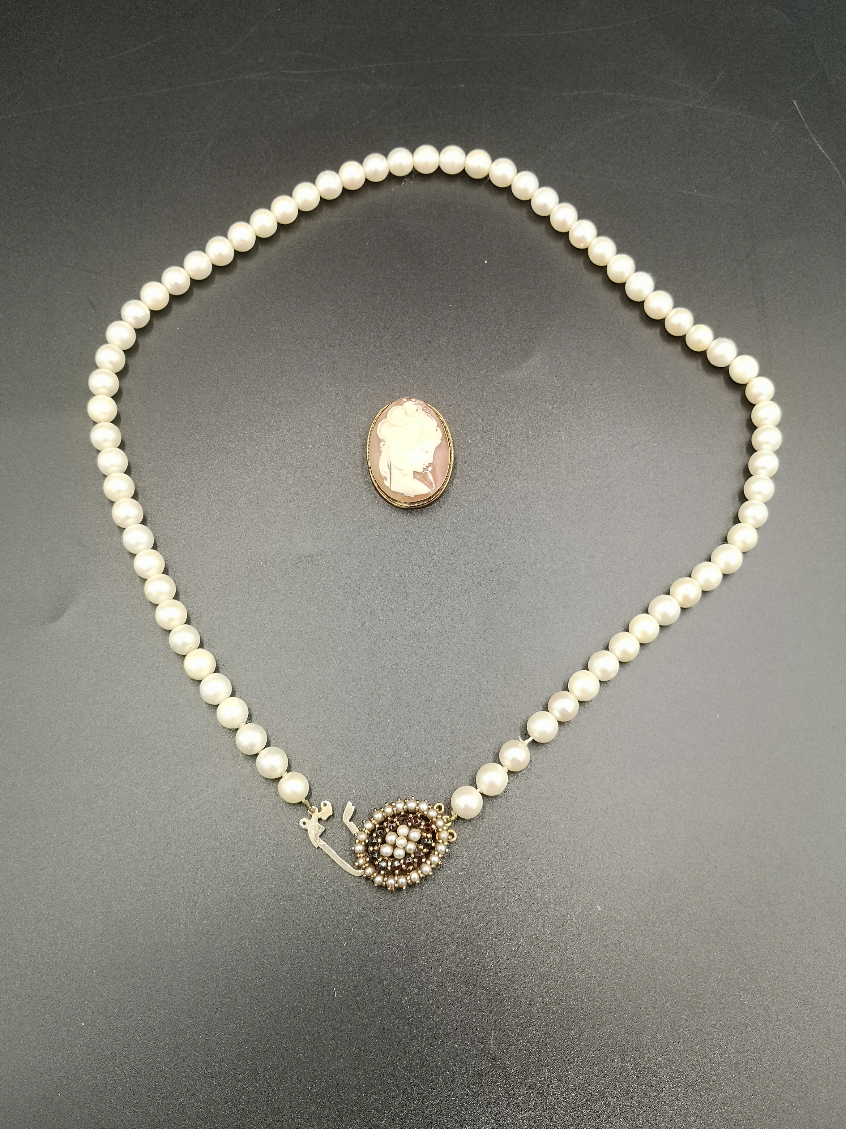 Cameo brooch together with a pearl necklace
