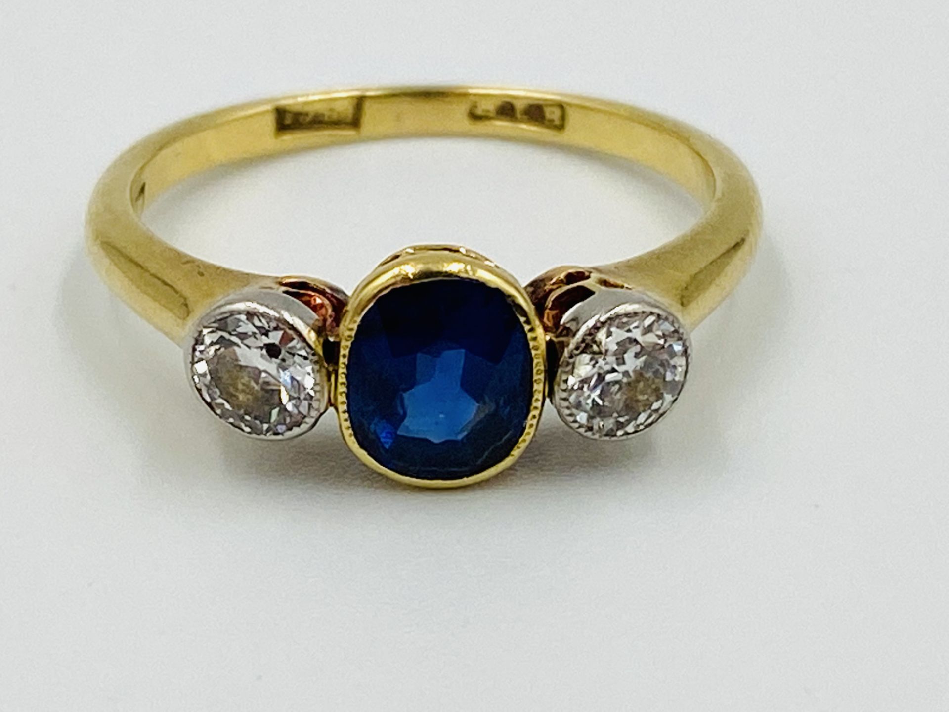 18ct gold, sapphire and diamond three stone ring