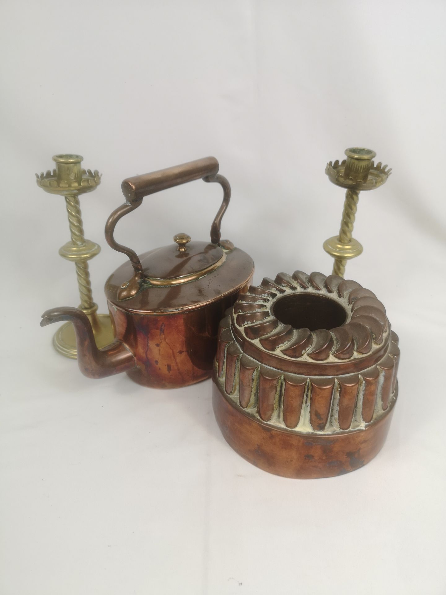 Victorian copper coal scuttle, copper jelly mould and pair of brass candlesticks