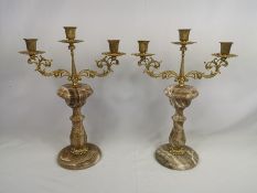Pair of gilt metal candelabras on onyx bases