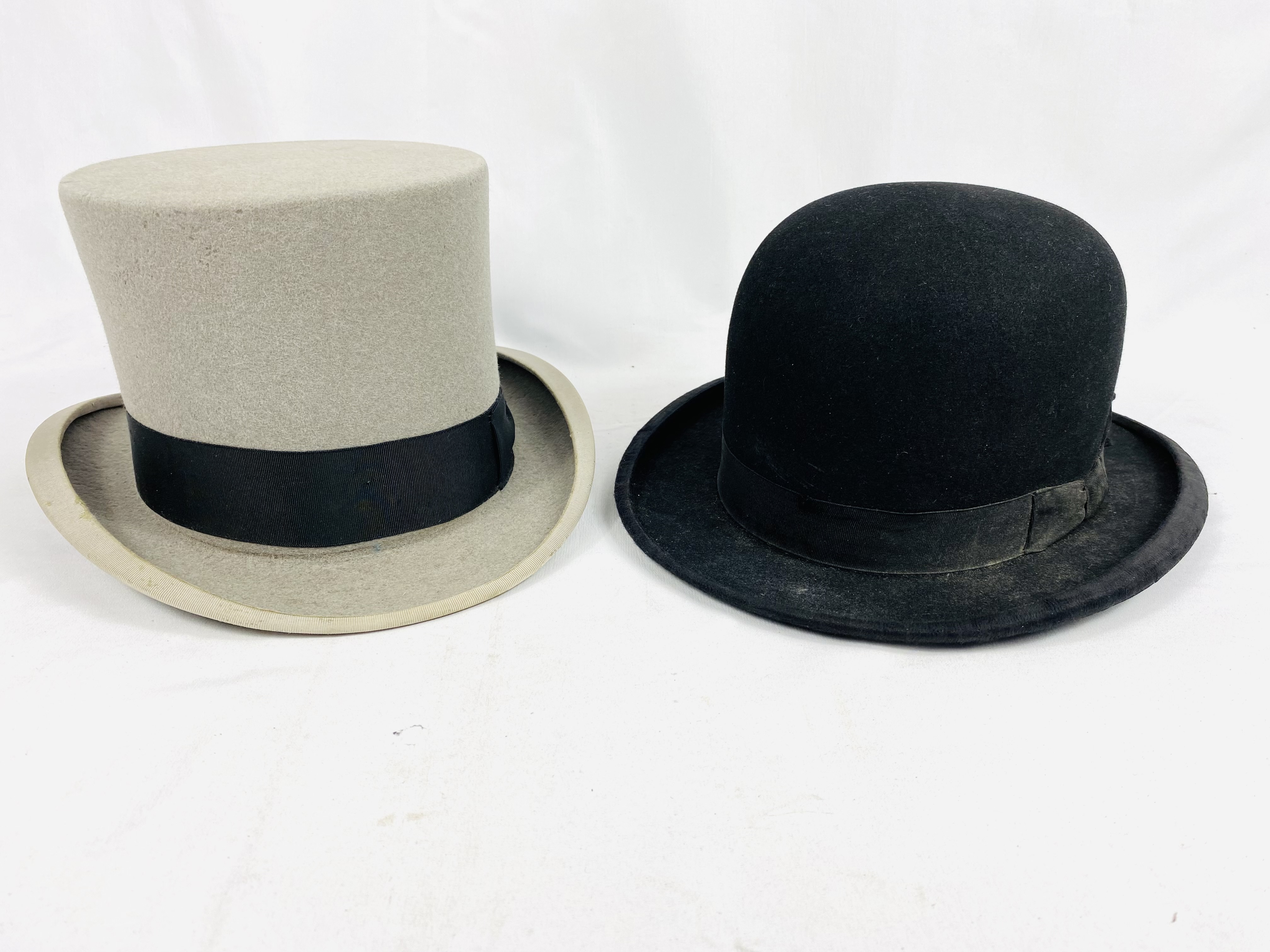 A Gieves Ltd bowler hat, internal dimensions; together with a Dunn & Co. grey felt top hat.