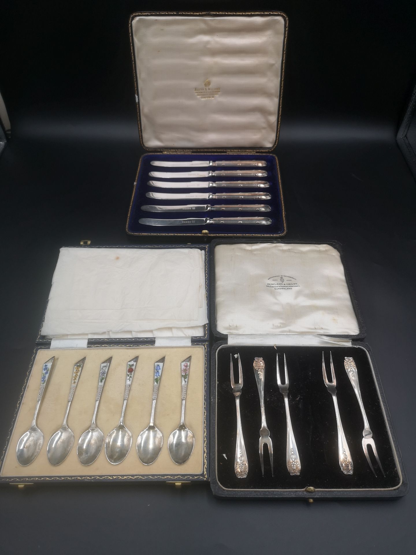 Set of six silver and enamel tea spoons together with silver handled knives and forks