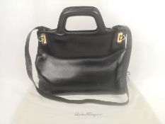 Salvatore Ferragamo black leather handbag with gold hardware and dust cover