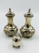 Pair of silver pepper pots together with a silver pepper pot