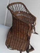 Antique basket saddle complete with stirrups.