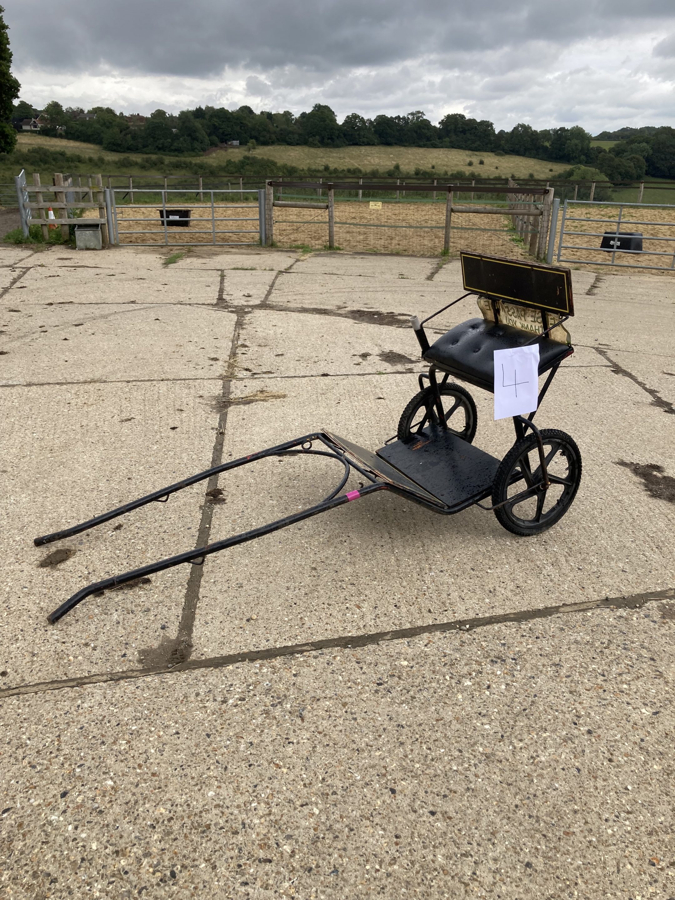 TWO WHEEL EXERCISE CART to suit a pony, painted black with black vinyl upholstery and on 5 spoke