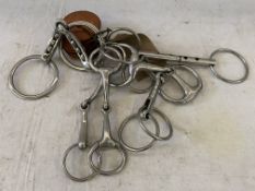 Six assorted stainless steel snaffles of various types together with 4 pairs of rubber bit guards