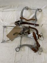 Seven various Western style bits including a Hackamore type