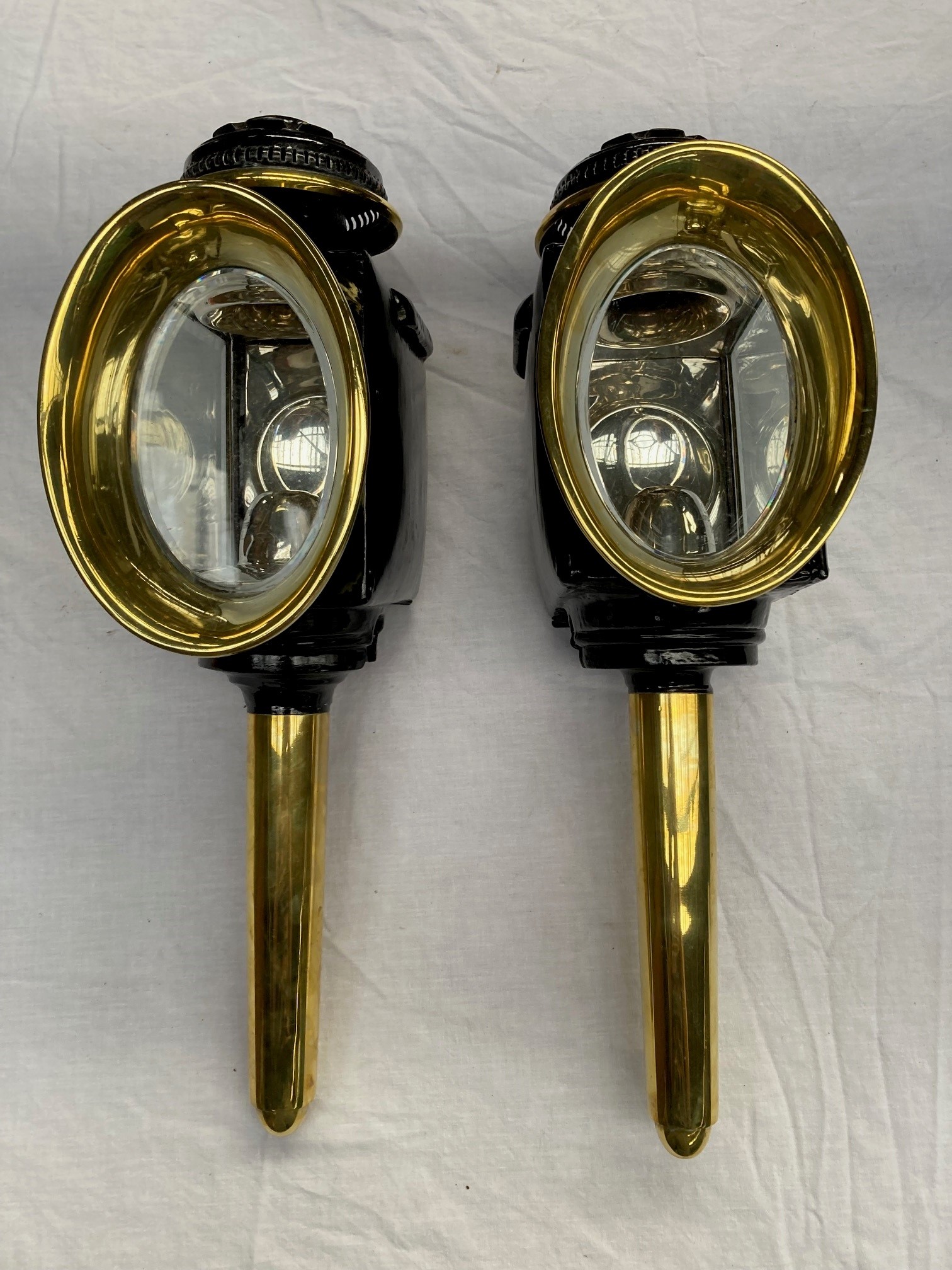 Pair of oval fronted lamps and rear lamp with bracket, by Lawton.