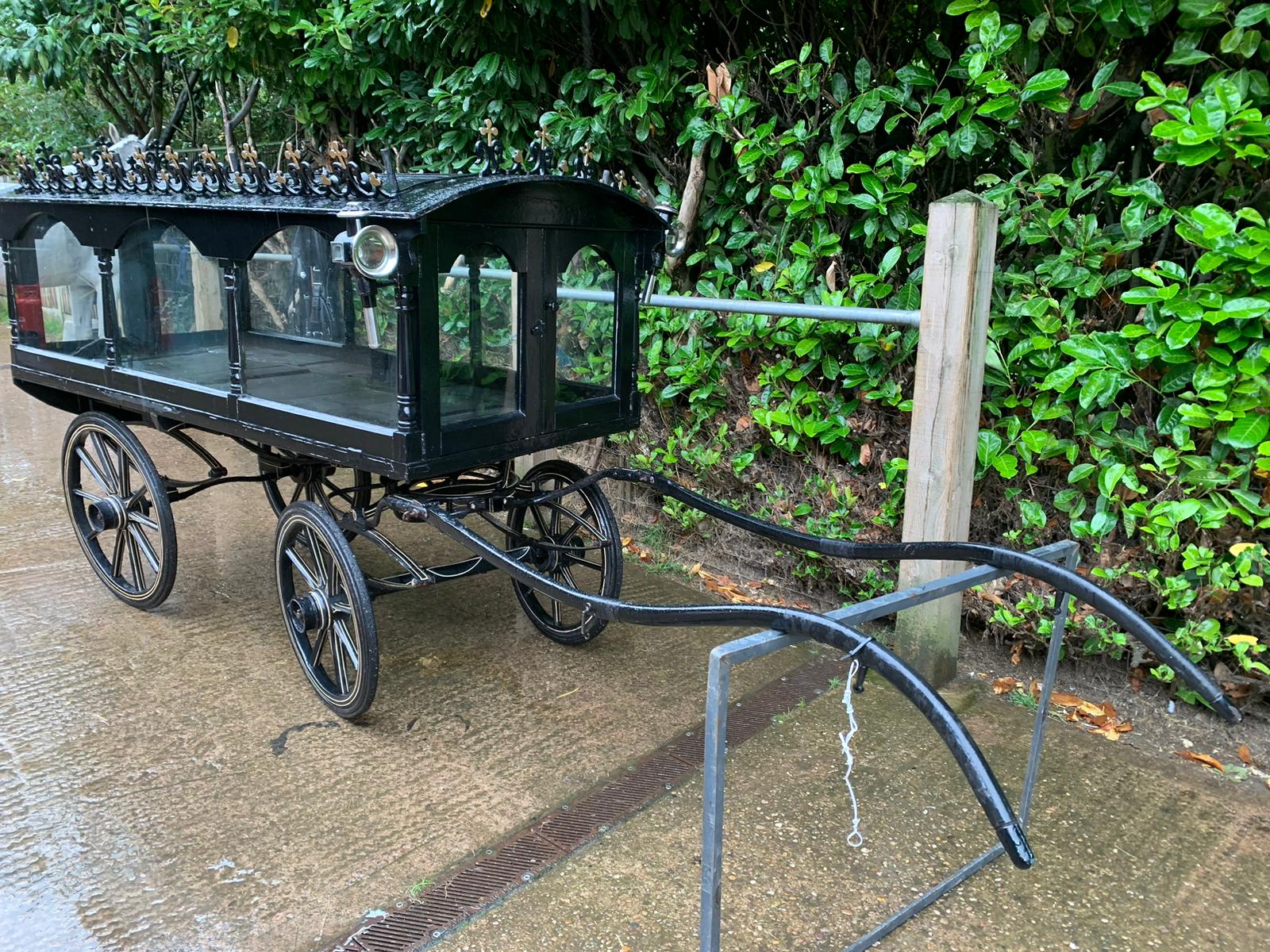PONY HEARSE to suit 12hh single. Painted black with the wheels lined in white. The decorative roof