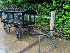 PONY HEARSE to suit 12hh single. Painted black with the wheels lined in white. The decorative roof