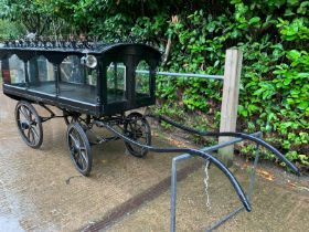 PONY HEARSE to suit 12hh single. Painted black with the wheels lined in white. The decorative roof