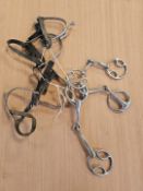 Nineteen assorted bits and 2 pairs of spurs