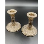 A pair of filled silver candlesticks