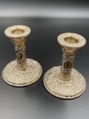 A pair of filled silver candlesticks