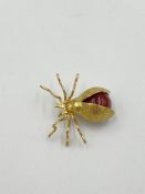 18ct gold spider brooch set with a carnelian cabochon