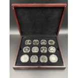 Twelve commemorative silver coins.