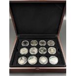 Twelve commemorative silver coins.