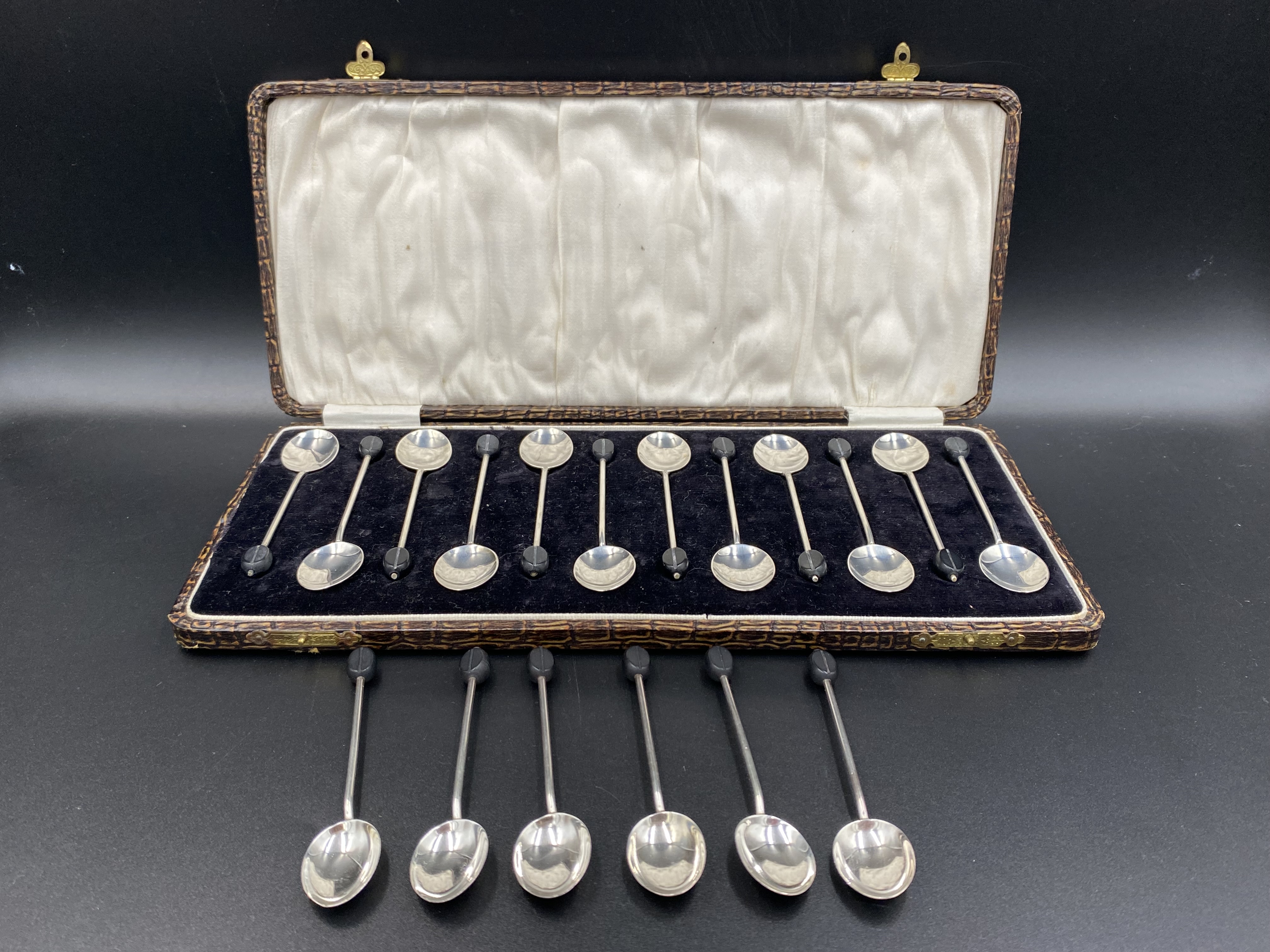 Twelve silver coffee bean spoons together with six coffee bean spoons