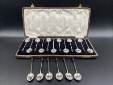 Twelve silver coffee bean spoons together with six coffee bean spoons