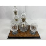 Contemporary cut glass brandy decanter and glass set, together with a decanter with a silver collar