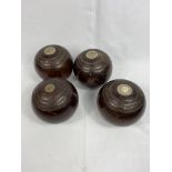 Four rosewood bowling balls