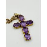 9ct gold cross set with amethysts, on a 9ct gold rope chain